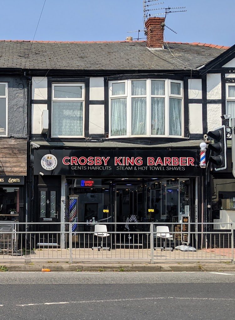 Crosby King Barber shopfront with a red and white sign and barber's pole